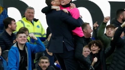 Everton interim manager Duncan Ferguson celebrates their third goal with a ball boy. Reuters