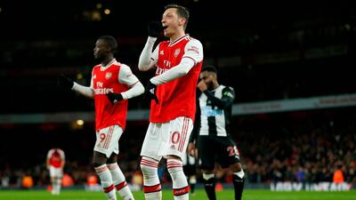 Arsenal's Mesut Ozil celebrates after scoring the third. AFP