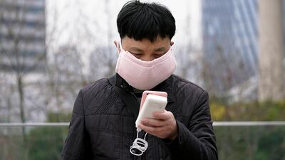 A man wearing a handmade face mask is seen in Shanghai, China, as the country is hit by a novel coronavirus outbreak, at the Pudong financial district in Shanghai, China. AP