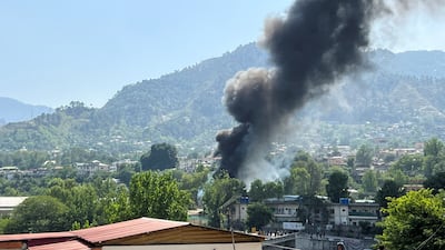 Smoke billows from the scene of the helicopter crash near Muzaffarabad, Pakistan. Reuters