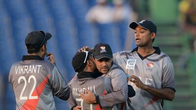 Khurram Khan, second from right, has served UAE cricket well for many years and will cap a long career with the World Cup. Munir uz Zaman / AFP
