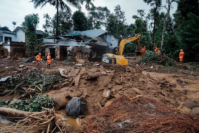 Rescuers search through mud and debris on Thursday after landslides hit Wayanad district in India's Kerala state early this week. AP