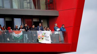 Fans watching from a nearby flat overlooking the ground in Manchester. Action Images via Reuters