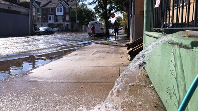 Water is pumped out of the basement of a home on Clifford Street on September 2, 2021 in Newark, New Jersey. AFP
