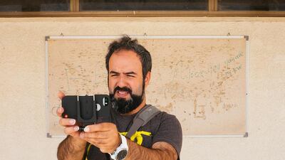 Hassan Kiyany filing his documentary about an abandoned school. Courtesy Ammar Al Attar
