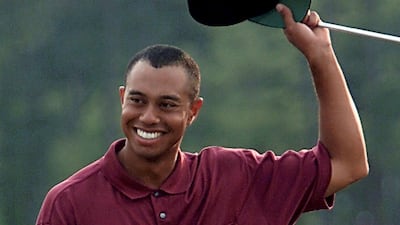 Tiger Woods waves to the gallery after sealing victory. AFP