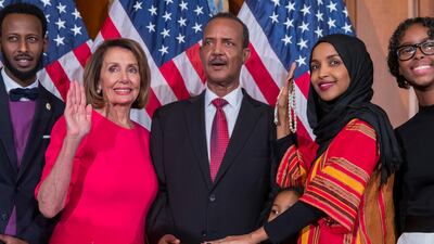 epa07260651 Democratic Representative from Minnesota Ilhan Omar (2-R), uses the Koran of her late grandfather while posing with new Democratic Speaker of the House Nancy Pelosi (2-L), during the first day of the 116th Congress at the US Capitol in Washington, DC, USA, 03 January 2019. EPA/ERIK S. LESSER