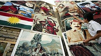 An Iraqi Kurd hangs a carpet with the image of the Kurdish regional president Massud Barzani, who is also the leader of the Kurdistan Democratic Party, which was been in power for the last 20 years. This week's vote saw the Change Group win 25 seats in the legislature, creating a serious opposition for the first time.