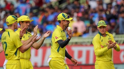 Australia's Mitchell Starc is applauded off the pitch by teammates after taking five wickets. AP