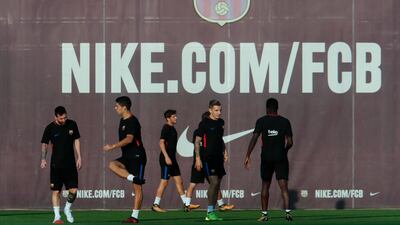 Barcelona player including Lionel Messi, left, take part in a training session. Pau Barrena / AFP