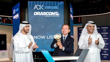 Osama Bishai, chief executive of Orascom Construction, centre, with Abdulla Al Nuaimi, chief executive of Abu Dhabi Securities Exchange, right, and ADX chairman Ghanem Al Mazrouei, during the Orascom listing ceremony at ADX on Thursday. Victor Besa / The National
