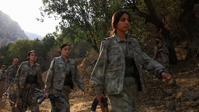 PKK fighters walk during a disarmament ceremony marking a significant step toward ending the decades-long conflict with Turkey. Reuters