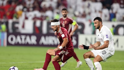 Al Wahda's Dusan Tadic battles with Al Sadd's Romain Saiss.