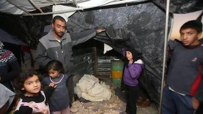 Abu Jamal, brother of Osama Salamat shows how floods took his tent in the camp of Al Zaatari for Syrian refugees. Salah Malkawi / The National