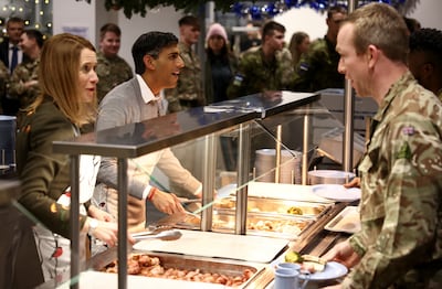 Ms Kallas and UK Prime Minister Rishi Sunak serve dinner to troops at a base in Tapa, Estonia. PA