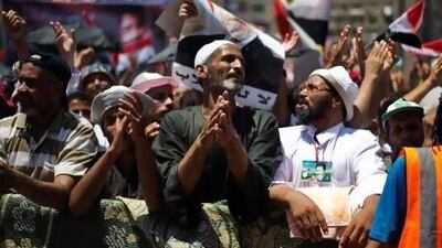 Muslim Brotherhood members and supporters of Mohammed Morsi outside the Rabaah Al Adawiya mosque on the first day of Eid Al Fitr.