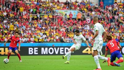 Algeria forward Abdelmoumene Djabou kicks the ball to score his team's third goal during their Group H match on Sunday against South Korea at the 2014 World Cup. Jung Yeon-Je / AFP