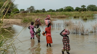 Children walk through flooded fields near Malualkon. Having already had to contend with a five-year civil war, hunger and corruption, South Sudan – the world's youngest country – now faces the challenge of extreme weather.