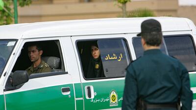 An Iranian policewoman looks out from a police vehicle before the start of a crackdown to enforce Islamic dress code in Tehran. AFP