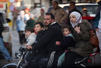 People ride a motorcycle near Masnaa Border Crossing after Syrian rebels announced that they have ousted Syria's President Bashar Al Assad. Reuters