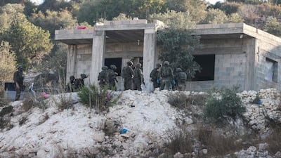 Israeli soldiers at the scene of the drone strike in the West Bank. AFP