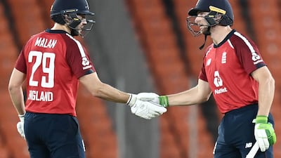 England's Jos Buttler, right, is congratulated by Dawid Malan after raching his 50. AFP