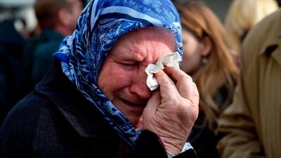 A woman cries in front of the International Criminal Tribunal for the former Yugoslavia (ICTY) in The Hague,on November 22, 2017, after Ratko Mladic was sentenced to life in prison for his role in "heinous crimes" committed during Bosnia's 1990s ethnic war