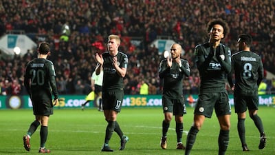 Manchester City players, including Kevin De Bruyne, second left, David Silva, centre, and Leroy Sane, right, salute the crowd after beating Bristol City. /Hannah Mckay / Reuters