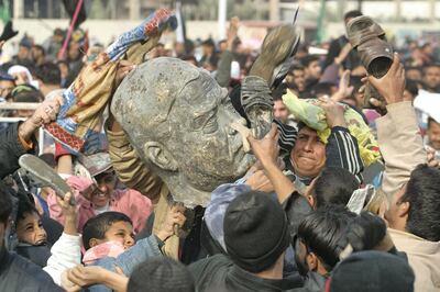 Iraqis beat a bust of ousted president Saddam Hussein in Sadr City in 2003. The US made its own miscalculations in the Middle East. AFP
