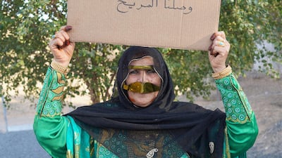 Khusaibah Al Dahmani holding up a sign saying 'we’ve reached Mars'. The photograph went viral on social media. Courtesy Alia Al Joker