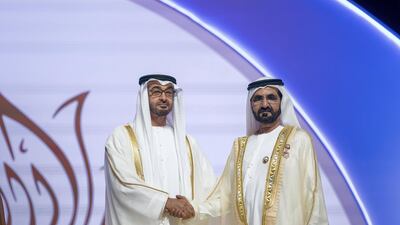 Sheikh Mohammed bin Zayed, Crown Prince of Abu Dhabi and Deputy Supreme Commander of the UAE Armed Forces, left, presents the Order of the Mother of the Nation to Sheikh Mohammed bin Rashid, Vice President and Ruler of Dubai during the Sheikha Fatima bint Mubarak Awards for Excellence and Social Creativity, at Emirates Palace. Mohamed Al Hammadi / Crown Prince Court - Abu Dhabi