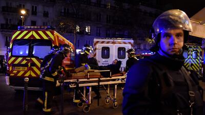 This photo taken on November 14, 2015 shows rescuers evacuating a man on a stretcher near the Bataclan concert hall in Paris as a number of people were killed in a series of gun attacks across Paris. Dominque Faget / AFP