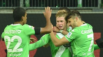 Kevin de Bruyne, centre, celebrates after scoring to give Wolfsburg a 3-0 lead against Bayern Munich. Carmen Jaspersen / EPA