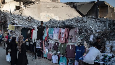 Women in Gaza City shop for clothes at a stall set up next to the rubble of destroyed buildings destroyed by Israeli air strikes during an 11-day war between Gaza's Hamas rulers and Israel. AP Photo