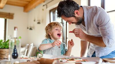 From preparing meals to playing singalong, fathers who co-parent take equal responsibility in raising their children. Photo: Getty