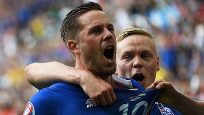 Iceland midfielder Gylfi Sigurdsson (L) celebrates after scoring his team’s first goal during the Euro 2016 Group F football match between Iceland and Hungary at the Stade Velodrome in Marseille on June 18, 2016. Anne-Christine Poujoulat / AFP