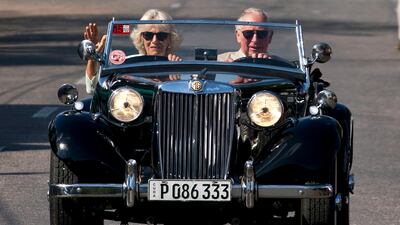 Britain's Prince Charles drives a vintage car with his wife Camilla, Duchess of Cornwall, during a cultural event in Havana, Cuba. This photo was chosen to be featured in their Christmas card. AP
