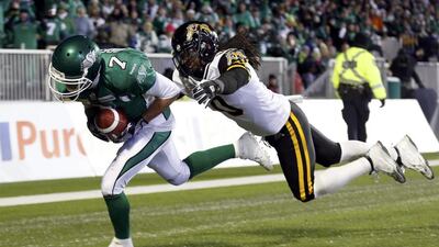 The Saskatchewan Roughriders Weston Dressler, left, scores a touchdown ahead of a last-ditch tackle from the Hamilton Tiger-Cats Rico Murray during the second half. Mark Blinch / Reuters
