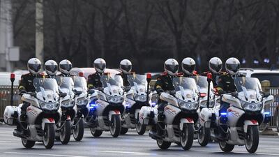 Police motorcycle escorts lead the motorcade Kim Jong-un in Beijing. AFP
