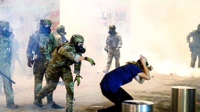 Federal officers use chemical irritants and crowd control munitions to disperse Black Lives Matter protesters in Portland. AP