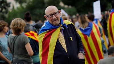 An elderly man joins a pro-independence gathering outside the Sagrada Família basilica i on the fifth day of protests over the conviction of a dozen Catalan independence leaders in Barcelona, Spain, Friday, Oct. 18, 2019. AP Photo/Bernat Armangue