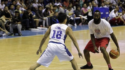 James Harden of the Houston Rockets, above, dribbles against a Philippines national basketball team member on Tuesday night during an exhibition drill in Quezon City, Philippines. Ritchie B Tongo / EPA / July 22, 2014