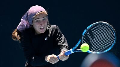 This handout picture released by the Tennis Australia shows Meshkatolzahra Safi of Iran hits a return as she competes during a girls doubles match on day eight of the Australian Open tennis tournament in Melbourne on January 24, 2022. (Photo by Morgan Hancock / TENNIS AUSTRALIA / AFP) / XGTY / RESTRICTED TO EDITORIAL USE - MANDATORY CREDIT "AFP PHOTO / TENNIS AUSTRALIA / MORGAN HANCOCK " - NO MARKETING NO ADVERTISING CAMPAIGNS - DISTRIBUTED AS A SERVICE TO CLIENTS