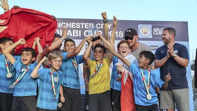 Tekkers Blue team, from Bahrain celebrates after winning the U-10 trophy at the Manchester City Abu Dhabi Cup. Victor Besa / The National