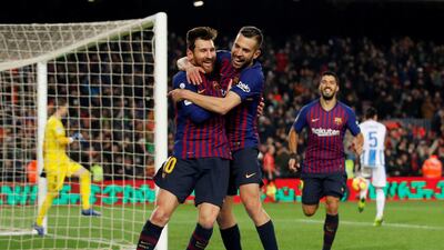 Lionel Messi celebrates scoring Barcelona's third goal with Jordi Alba. Reuters