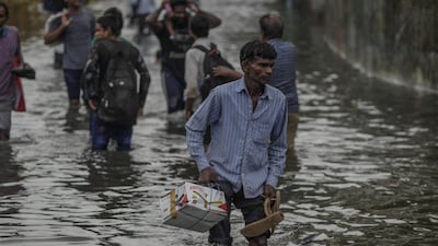 Pedestrians wade through flood water in Mumbai, India, on Tuesday, July 2, 2019. Bloomberg