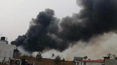 Smoke rises following the crash of a Bangladeshi aircraft at Kathmandu airport, Nepal on March 12, 2018. Rusha Giri / via Reuters