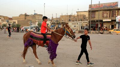 An Iraqi boy rides a horse during Eid Al Fitr celebrations at an amusement park in Sadr city, Baghdad, Iraq. EPA