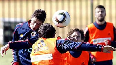 Fernando Torres wins an aerial challenge during a Spanish training session as the team prepare for their opening game of the World Cup against Switzerland today.