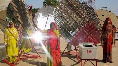 Barefoot College women with their solar cookers. The lady in red is Norti Devi, who has been building the cookers for six years.